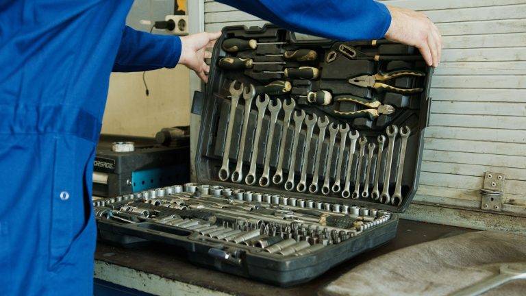 A man opening his toolbox to provide good service for manufacturing lines